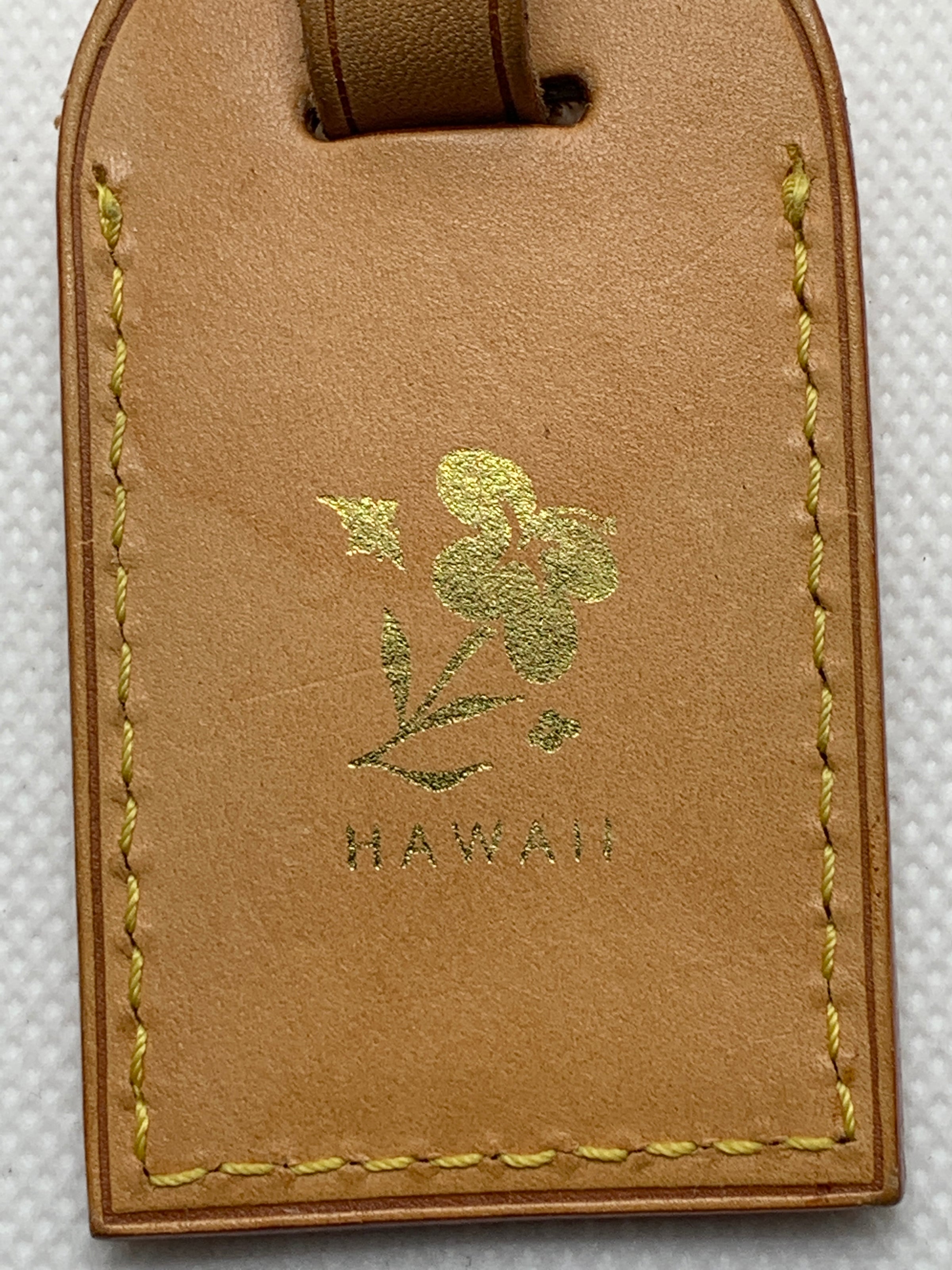 Louis Vuitton luggage tag with Hawaii flower heat stamped in gold