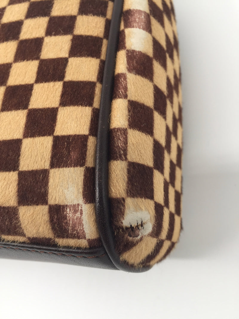 The limited-edition Louis Vuitton Damier Sauvage calfskin Vivian bag is an  exquisite piece.…